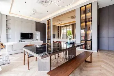 Luxurious open-plan living room with elegant dining area and modern decor