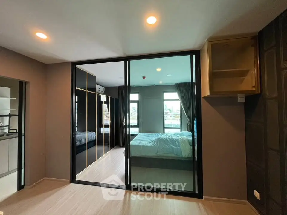 Modern bedroom with glass sliding doors and city view