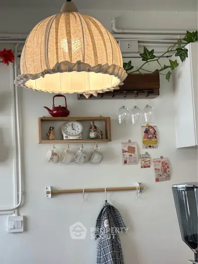 Charming kitchen with vintage decor, hanging cups, and cozy lighting.