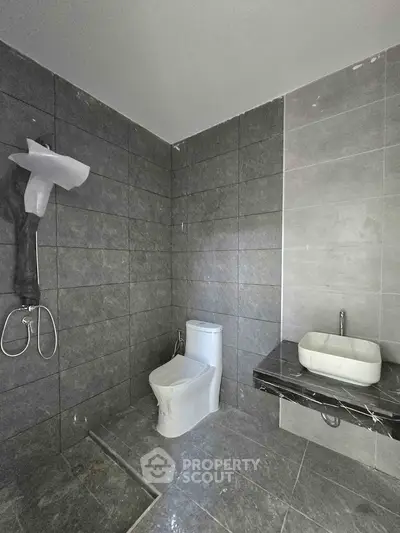 Modern bathroom with sleek gray tiles and contemporary fixtures