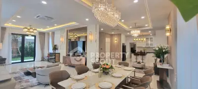 Luxurious open-plan living and dining area with elegant chandeliers and modern decor.