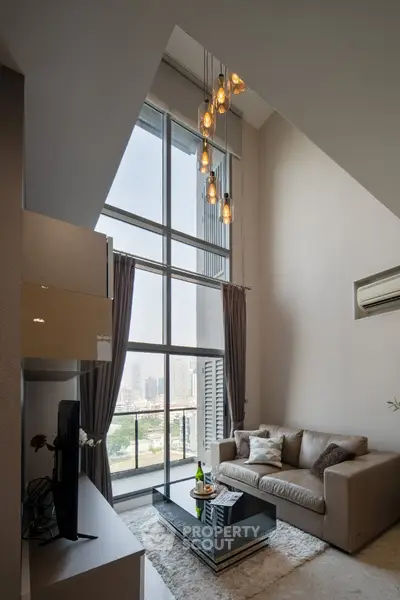 Luxurious high-ceiling living room with stunning city view and modern decor