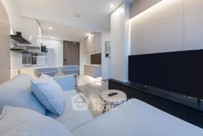 Modern living room with sleek furniture and open kitchen layout in a stylish apartment.