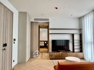 Modern living room with stylish wooden accents and large TV setup