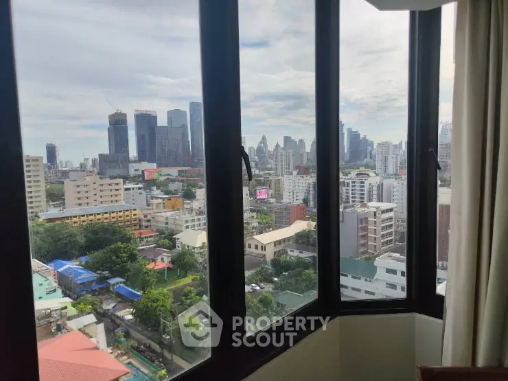 Stunning cityscape view from high-rise apartment window, showcasing urban skyline and vibrant city life.