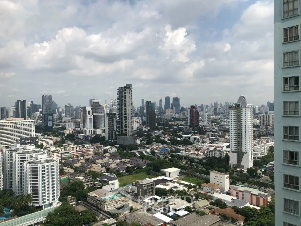 Stunning cityscape view showcasing modern skyscrapers and urban landscape under a cloudy sky.