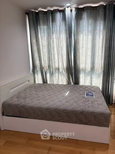 Bright bedroom with large windows and modern bed, perfect for cozy living.