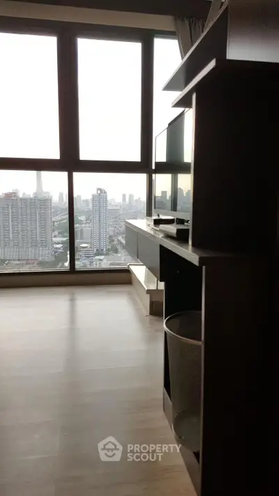 Modern high-rise apartment with stunning city view from large windows