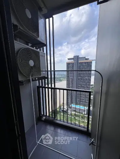 High-rise balcony with air conditioning units and city view.