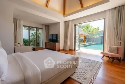 Luxurious bedroom with pool view and elegant decor in a modern home