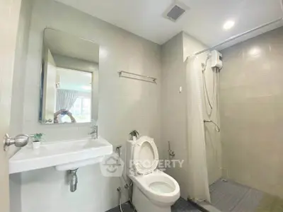 Modern bathroom with shower and sleek fixtures in a bright setting.