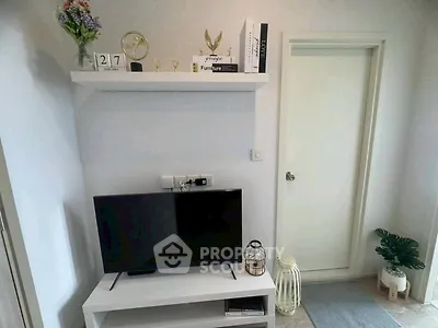Modern living room with stylish decor and flat-screen TV, showcasing contemporary interior design.
