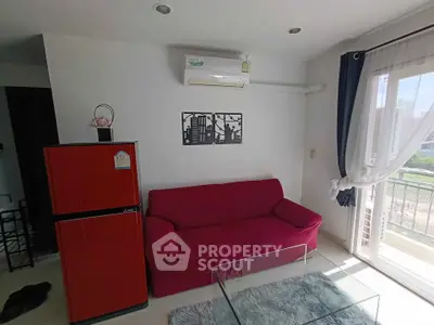 Charming living room with red sofa, modern decor, and balcony view in a bright apartment.