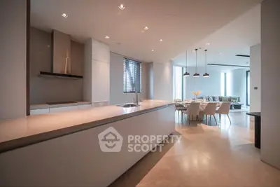 Luxurious open-plan kitchen and dining area with modern design and ample natural light.
