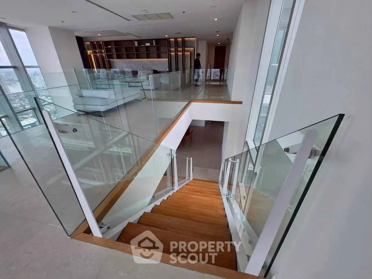 Luxurious modern duplex with glass railings and spacious living area