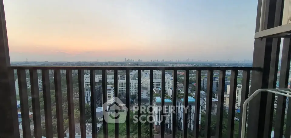 Stunning cityscape view from a high-rise balcony at sunset, showcasing urban living.