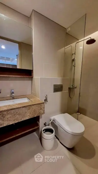Modern bathroom with sleek fixtures and glass shower enclosure