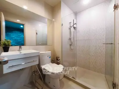 Modern bathroom with glass shower and sleek fixtures