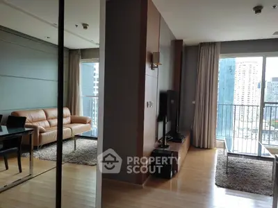 Modern living room with city view, featuring sleek furniture and large windows for natural light.