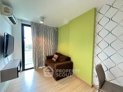 Modern living room with green accent wall and balcony view