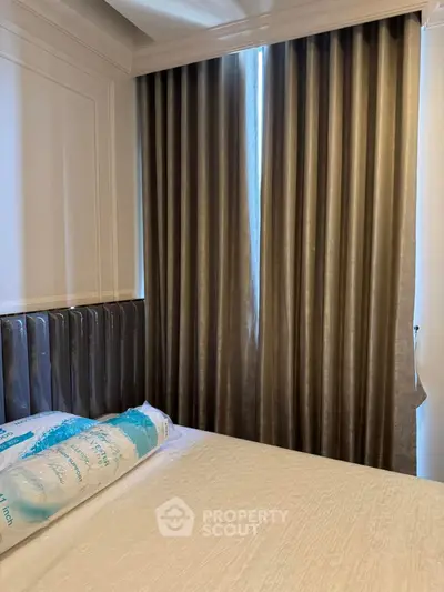 Cozy bedroom with elegant curtains and comfortable bedding