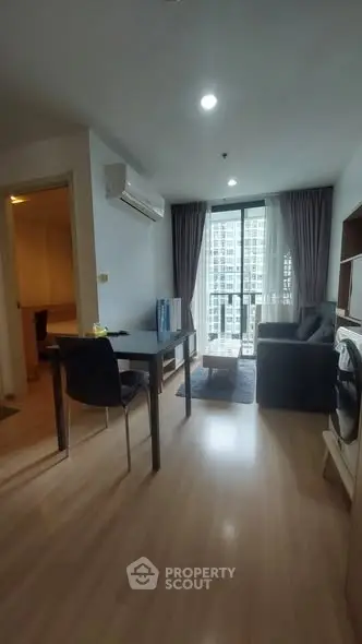 Modern living room with city view, featuring sleek furniture and natural light.