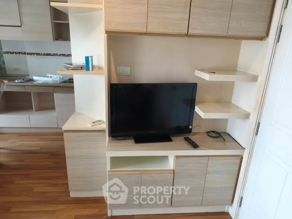 Modern living room with built-in TV cabinet and wooden flooring