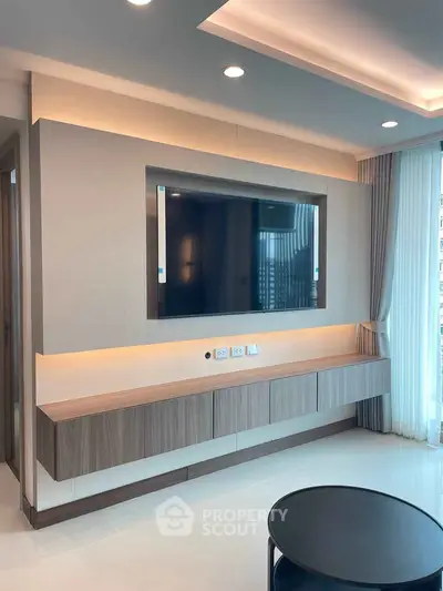 Modern living room with sleek TV setup and elegant lighting