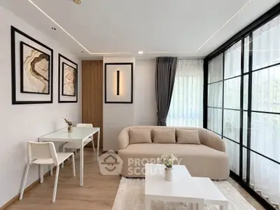 Modern living room with elegant decor and large windows for natural light
