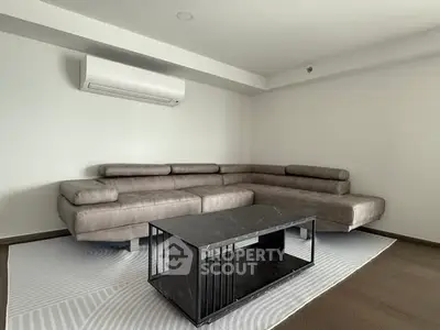 Modern living room with sleek sectional sofa and minimalist coffee table.