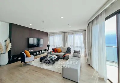 Spacious modern living room with elegant decor and large windows offering natural light.