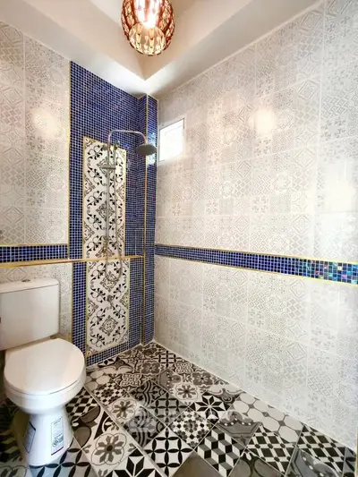 Chic bathroom with intricate tile design and modern shower fixtures.
