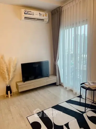 Modern living room with stylish decor and large window for natural light.