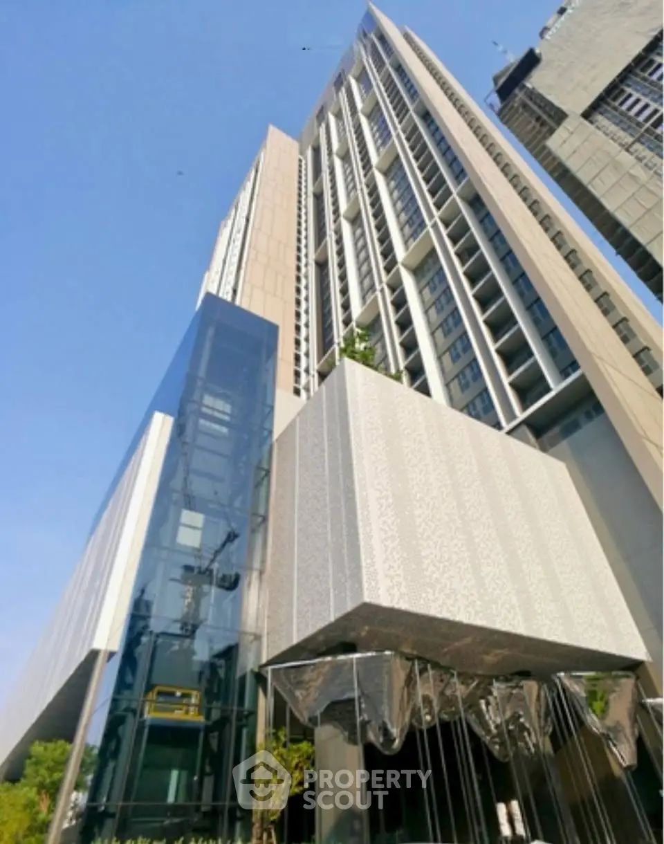 Modern high-rise building with sleek glass facade and architectural design