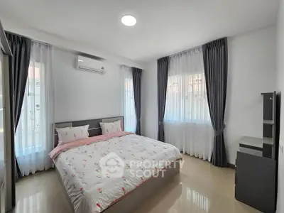 Spacious bedroom with modern decor and natural light