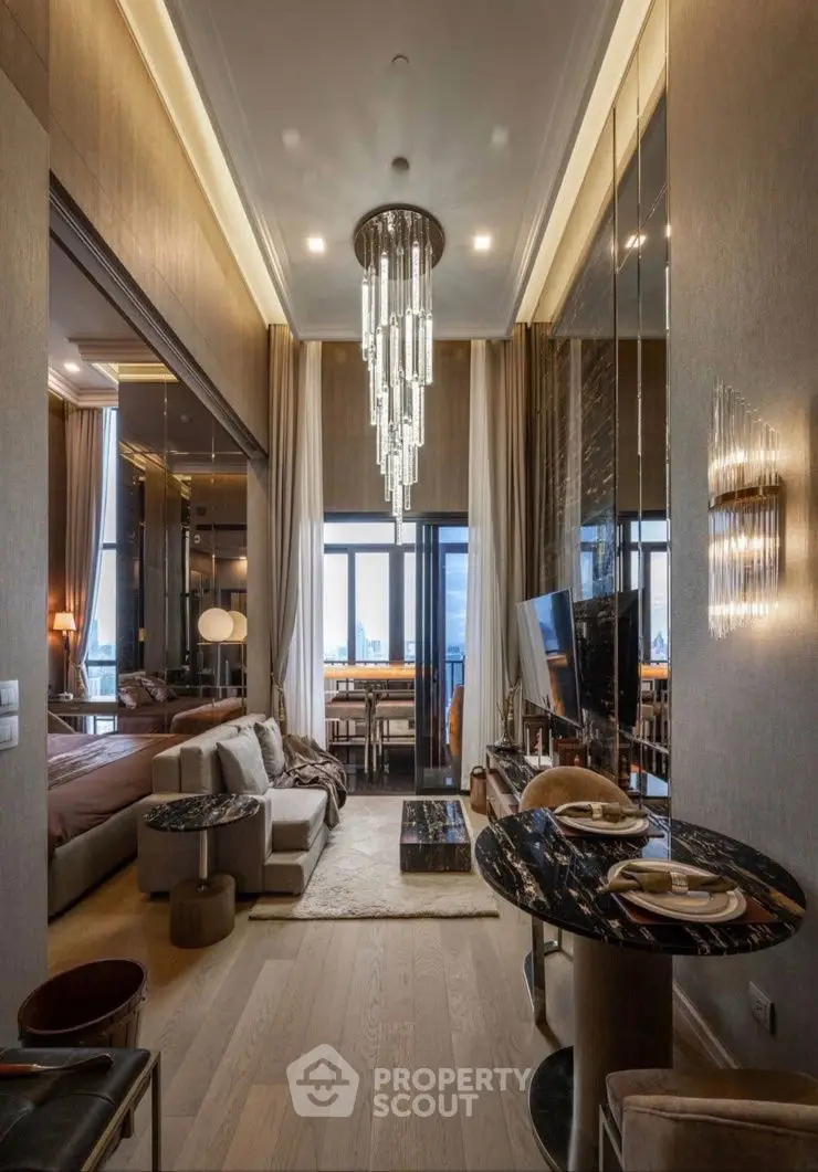 Luxurious modern living room with elegant chandelier and stunning city view.