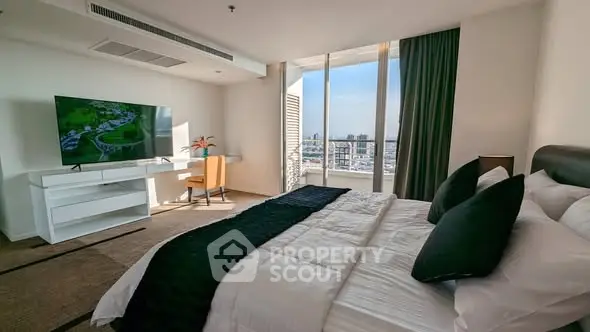 Luxurious bedroom with city view, modern decor, and large TV in high-rise apartment.