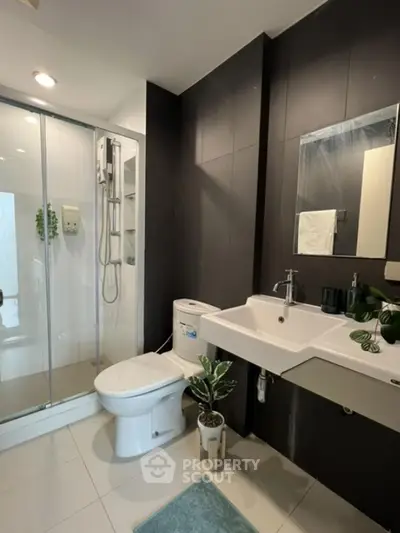 Modern bathroom with sleek fixtures and glass shower enclosure