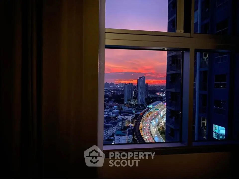 Stunning cityscape view from a high-rise window at sunset, showcasing vibrant urban life.