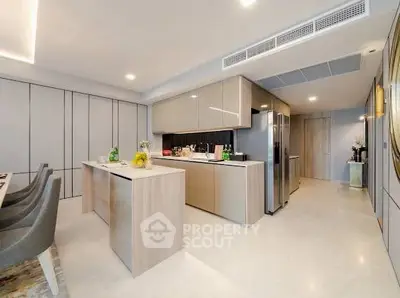 Modern kitchen with sleek cabinetry and island in luxury apartment