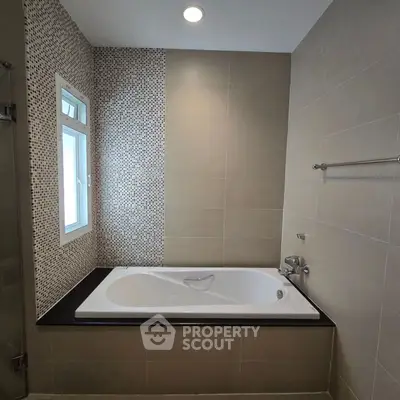 Modern bathroom with elegant bathtub and stylish tile design