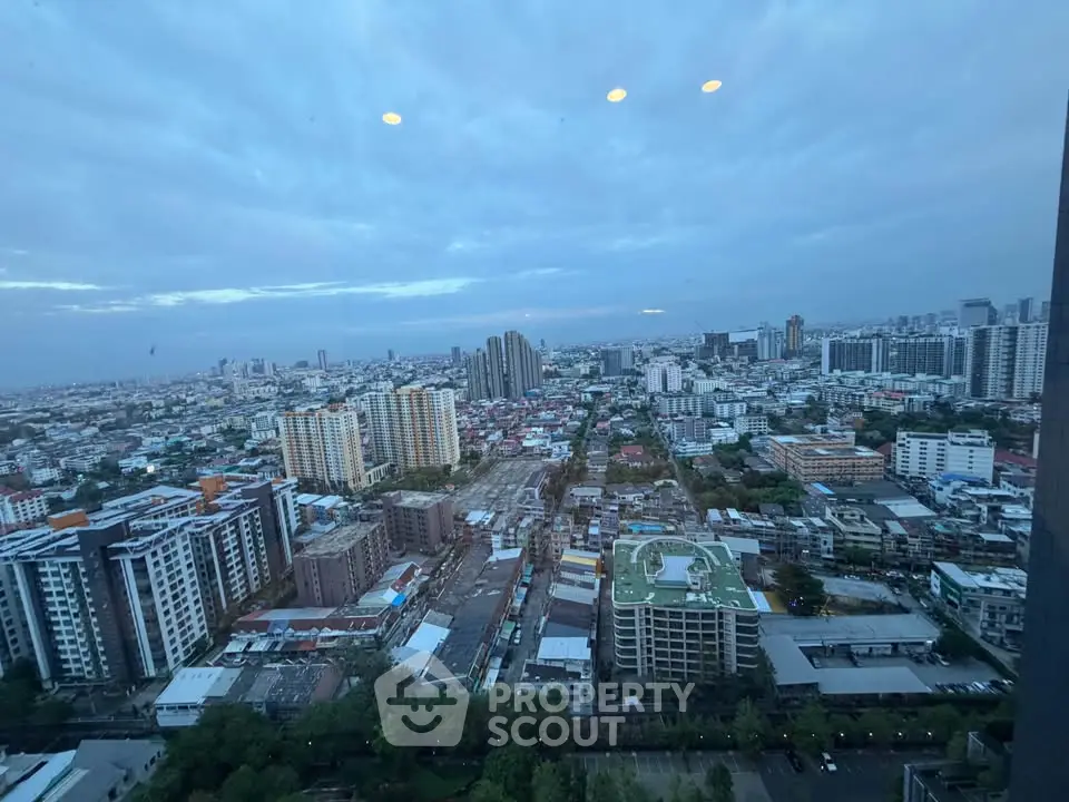 Stunning cityscape view from high-rise building showcasing urban skyline and residential areas.