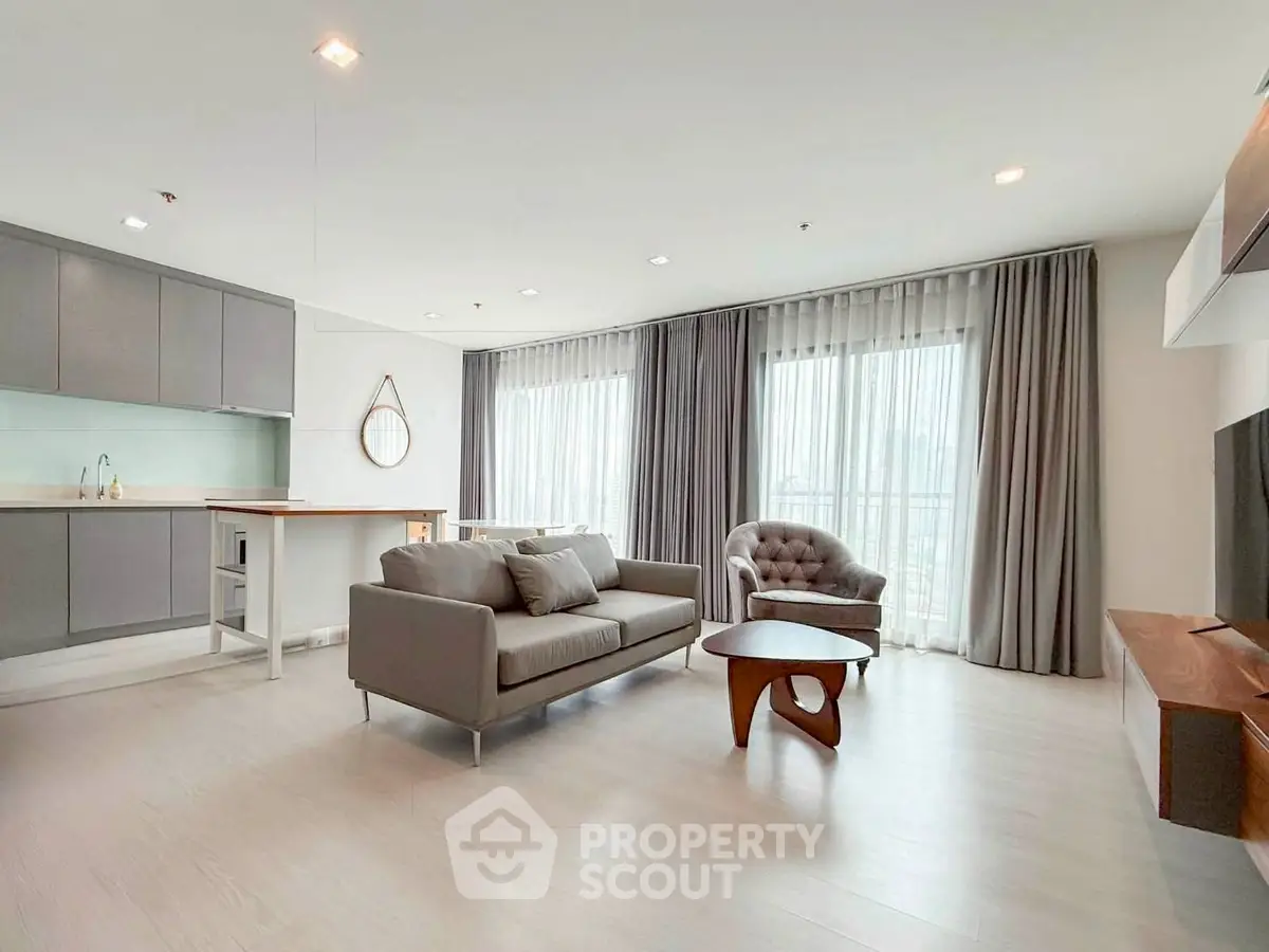 Spacious modern living room with open kitchen and elegant furnishings