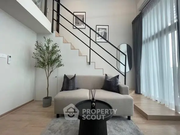 Modern living room with loft-style staircase and elegant decor