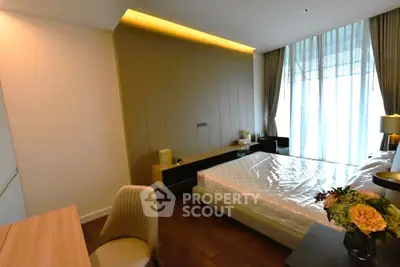 Luxurious bedroom with modern decor and large window for natural light