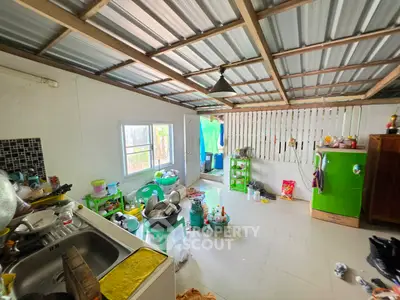 Cozy kitchen with open layout and vibrant green fridge, perfect for culinary creativity.