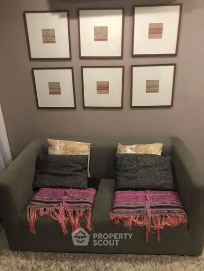 Cozy living room with stylish sofa and framed art on wall