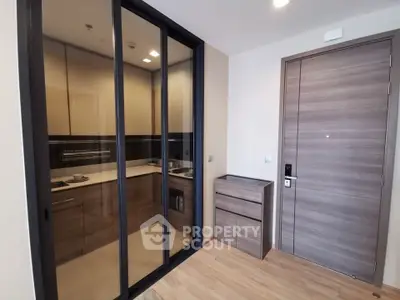 Modern apartment entrance with sleek kitchen and stylish cabinetry