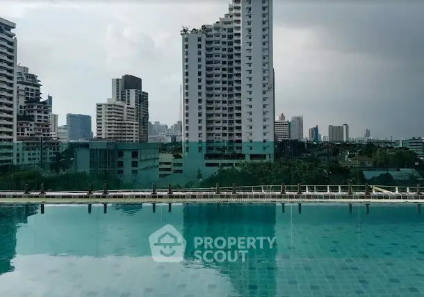 Stunning cityscape view from rooftop pool in modern urban setting.