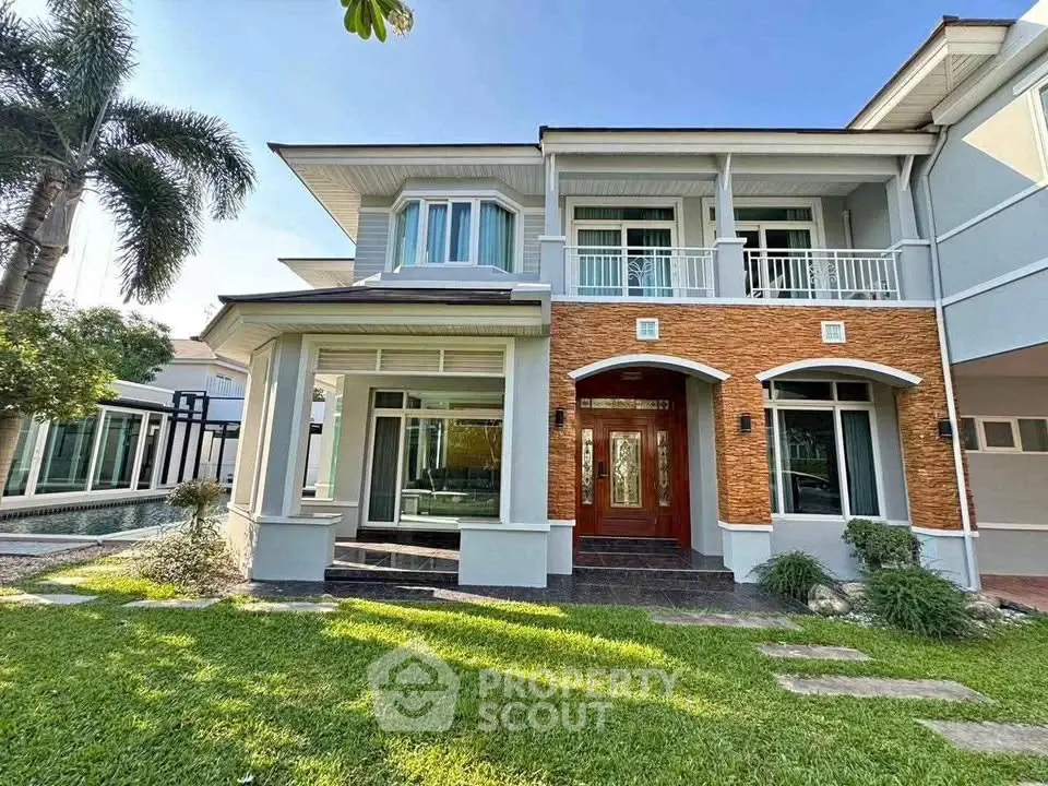 Elegant two-story house with lush garden and modern facade